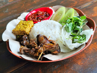Lalapan. Lalapan traditional Indonesian food. Lalapan traditional Indonesian food, consisting of fresh vegetable rice served with chili sauce, tempeh and offal.