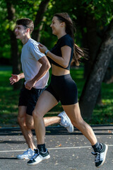 Couple jogging together in the park, promoting fitness, healthy living, and a shared active lifestyle. Captures outdoor exercise, bonding, and the energy of a scenic park trail...