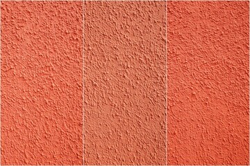 Fototapeta premium Three different shades of red are shown on a wall. The wall is covered in a textured surface, giving it a unique appearance. The colors are arranged in a row, with the lightest shade on the left