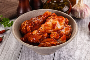 Raw marinated buffalo chicken wings