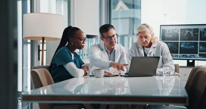 Hospital, teamwork and doctors on laptop in meeting for consulting, discussion and medical advice. Healthcare, clinic and man and women on computer for collaboration, research or telehealth website