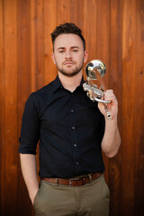 Confident trumpet player against wood background