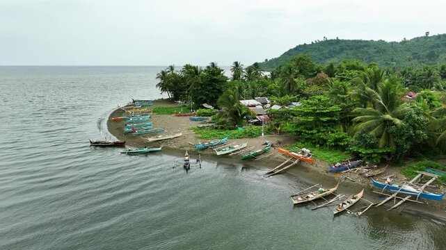 Title: Eastern Samar Coastal Village Life: Fishing Boats on Shore in a Tropical Philippine Setting