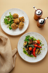grilled vegetables with herbs and sauce and falafel