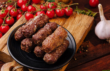 Delicious grilled meat rolls served with fresh ingredients