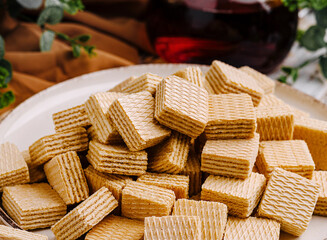 Delightful wafers arranged on a plate with a refreshing drink