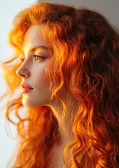 Fototapeta premium Close-up portrait of a young woman with long, curly red hair. her hair is styled in loose curls that frame her face and cascades down her back.