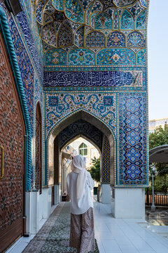 Muslim woman walking in a corridor of the imam reza shrine, mashhad, iran