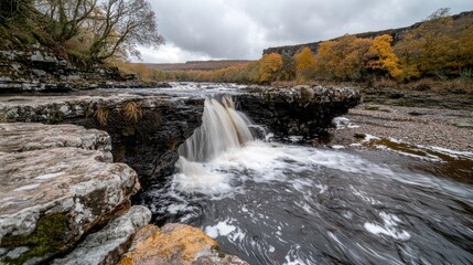 Obraz premium Autumn Waterfall in a Rocky Gorge; Natural Beauty