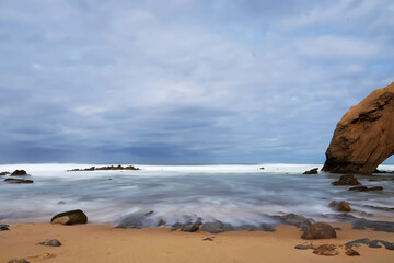 Rocks on the beach with stormy sky
