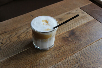 Huge Cup Of Cold Creamy Cappuccino With Straw On A Old Table Of Cozy Cafe 