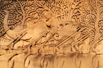 A bas relief, bas-relief, stone carving on a wall of the Bayon Temple, an elephant and many warriors, Angkor Wat, Siem Reap, Cambodia