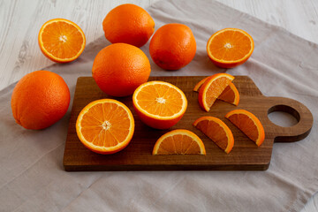 Raw Organic Sweet Oranges on a wooden board, side view.