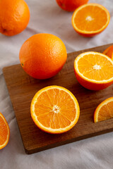 Raw Organic Sweet Oranges on a wooden board, side view.
