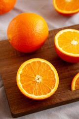 Raw Organic Sweet Oranges on a wooden board, side view.