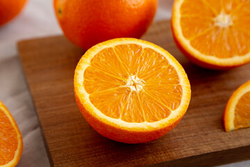 Raw Organic Sweet Oranges on a wooden board, low angle view. Close-up.