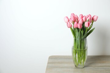 Beautiful fresh tulips in a vase on the table