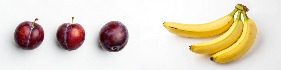 Fototapeta premium Three plums and a bunch of bananas arranged artistically on a white background.