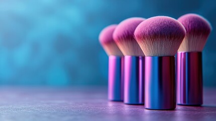 Pink makeup brushes on table, blue backdrop, beauty blog