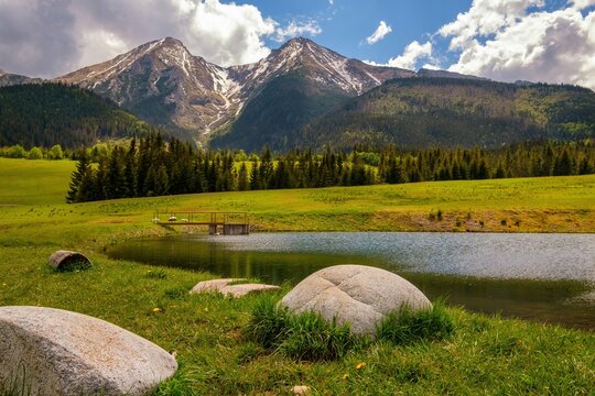 Mountain lake in the High Tatras - Slovakia. The two highest mountains of the Belianske Tatra, Havran and Zdiarska vidla, in the evening sun.