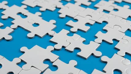 Close-up of white puzzle pieces on a blue background with missing sections, symbolizing problem-solving, connection and teamwork in a conceptual and minimalist design