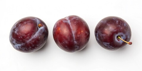 Obraz premium Three plums showcasing their rich colors and smooth surfaces, elegantly displayed on a light backdrop.