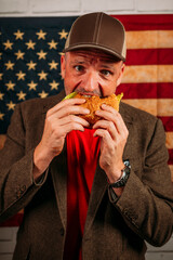 American man eating a hamburger.