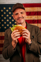 American man eating a hamburger.