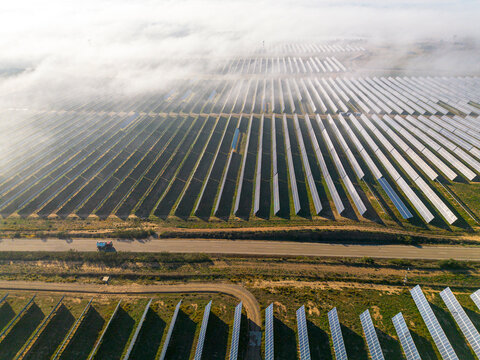 Fog-covered solar farm in Teruel, Zaragoza, Spain, blending atmospheric elements with clean energy production.