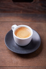 Cup of coffee on wooden background. Soft focus. Copy space