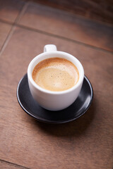 Cup of coffee on wooden background. Soft focus. Copy space