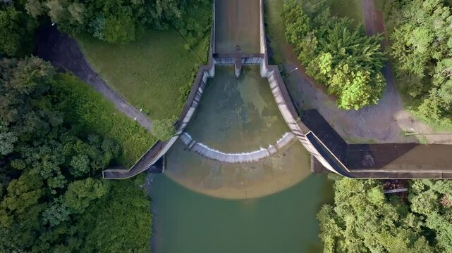 Hatillo Dam water reserve in Dominican Republic. Aerial top down landing shot. Tropical forest and barrier.