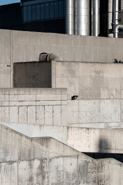 Urban brutalist building with exposed concrete surfaces, highlighting raw textures and modern geometry.