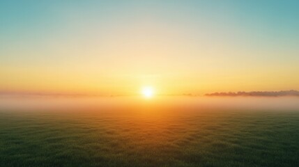 Fototapeta premium Peaceful sunrise over misty field with green grass and clear sky