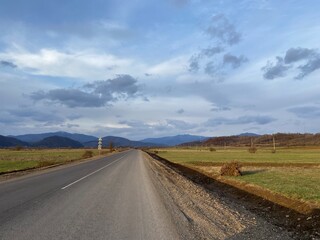 Fototapeta premium Scenic highway through nature. Countryside road at sunset 