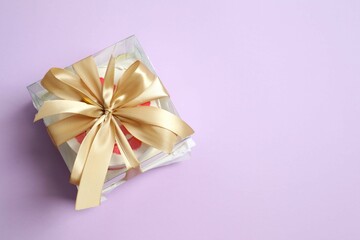 Colorful packaged cake decorated with red lips on a colored background