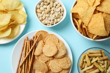 Various unhealthy snacks on a colored background