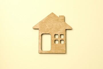 Wooden house on color background