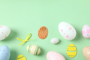 Happy Easter card. Easter eggs and decoration on color background, top view