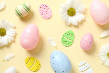Easter eggs and decoration with flowers on color background, top view