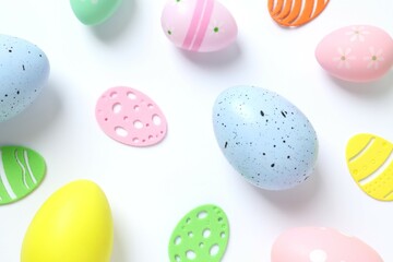 Happy Easter card. Easter eggs and decoration on white background, top view