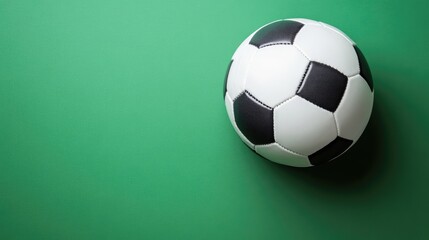 Flat lay of a classic soccer ball on a fresh green background, sharp focus, no people