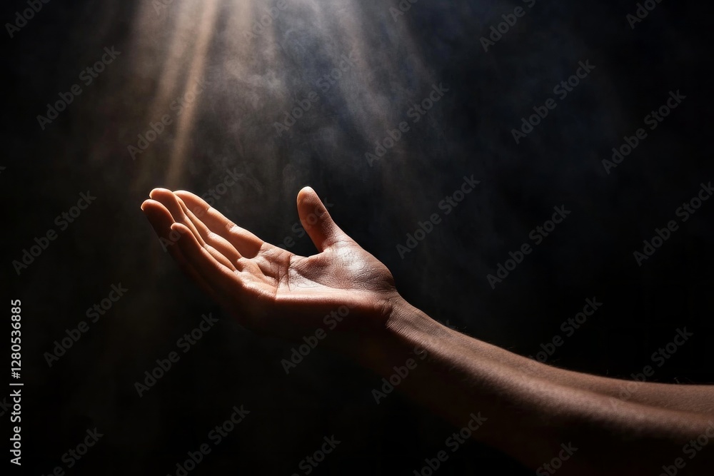 Poster in a moment of stillness, two hands stretch downward from the darkness, welcoming the soft illuminat