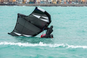 Wingfoil is a sport combining kitesurfing and windsurfing. Moment of getting into the water and raising the sail. Wing foil is a dynamically developing sport for everyone