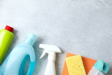 Many different house cleaning products on color background, top view