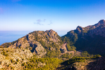 Picturesque aerial view Tramuntana mountain range under blue sky. Beauty of Mallorca, Balearic Islands, Spain