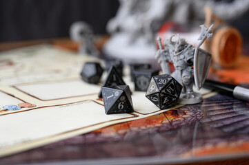 Close up of black d20 on character sheet. Board games, RPG, abstract concept of randomness and...