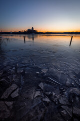 Dome of Ratzeburg in Winter at sunset with sheets of ice in foreground, Schleswig-Holstein, Northern Germany