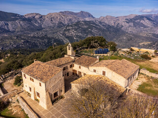 Obraz premium aerial view of the hermitage and Alaró Castle hostelry , Alaró hill, Dry stone route, Natural area of the Serra de Tramuntana., Majorca, Balearic Islands, Spain