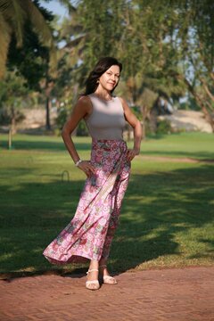 Beautiful woman age model 51 years old posing in a silk skirt in Goa India